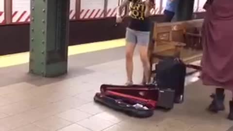 Nyc violin player man shuffles past