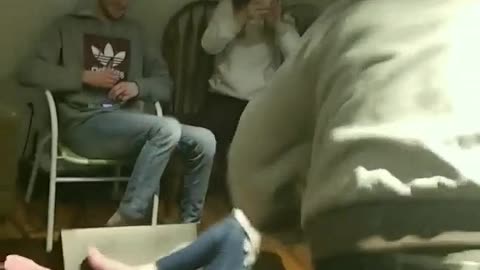 Guy wrestles girl, picks her up over his shoulders, and throws her onto a table