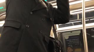 Man yells on subway train uses a bottle of cranberry juice as a microphone
