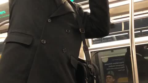 Man yells on subway train uses a bottle of cranberry juice as a microphone