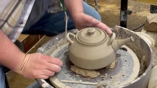 Trimming and putting on the spout of a Teapot.