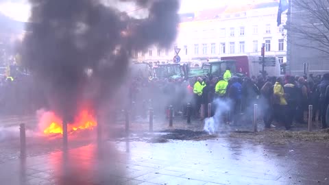 Police hose farmers at EU Parliament protest