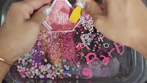 Barbie slime mixing makeup glitter into slime