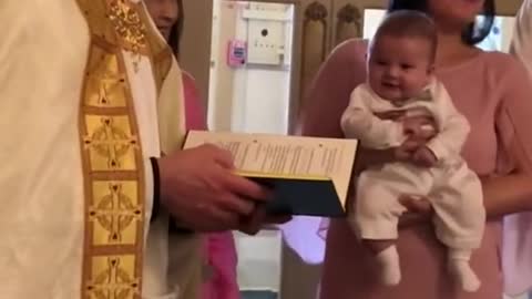 Baby boy laughing and giggling during baptism| 3months old