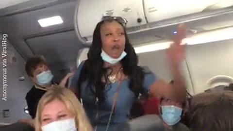 She takes off her mask in the plane and says she is the queen