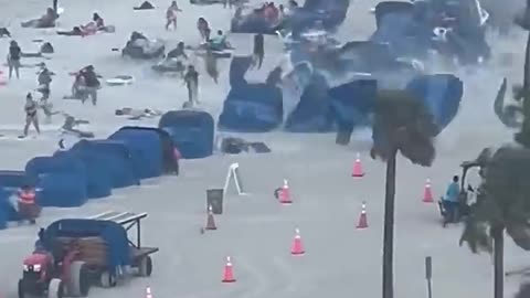 Foot captures waterspout ripping through crowded beach