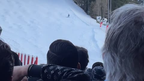 Crowd Cheers for Skier Coming Down Slope