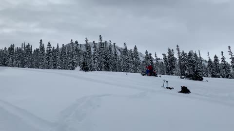 Guy Gets Thrown Off A Snowmobile When It Flips As He Drives Downhill