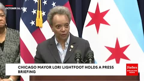 Mayor Lori Lightfoot signs an executive order