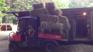 Daniel dumping the second load of hay with the RTV 900.