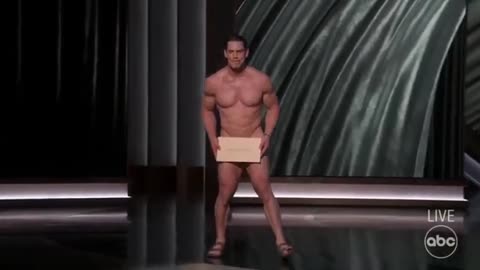 Naked John Cena appears on the Oscar stage.