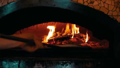 Cooking pizza in a traditional oven