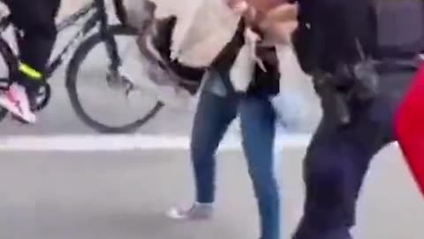 Woman in Denmark gets thrown around by police for trying to stop a Quran burning.