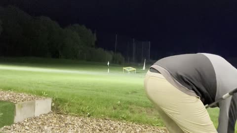 Hitting driver down the range.