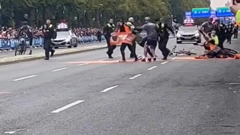 Just Stop Oil protestors try to stand in front of a marathon in Berlin