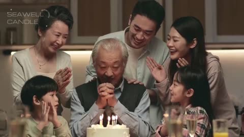 Three Generation Asian Family Celebrating Grandpa's Birthday at Home with Cake and Candle Lights
