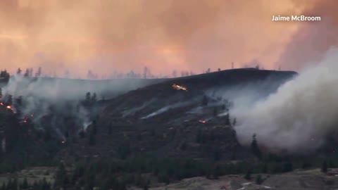 Plane fights wildfire raging in Montana