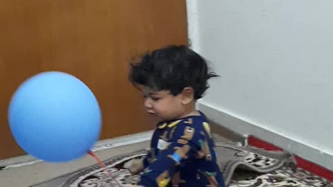 Charming child playing with balloons