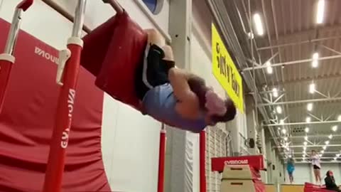 Toddler Accompanies Gymnast Dad While He Practices Cool Tricks