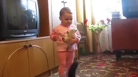 "Adorable Showdown: Baby vs. Cat Mama - A Tug of Love!"