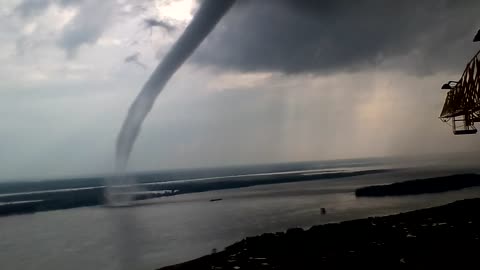 Waterspout Swirling Near Crane Operator