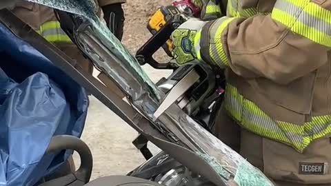 Firemen break down the accident car