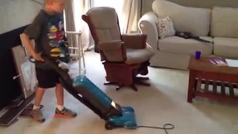 The boy plays with his brothers with their mother cleaning the house