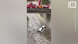 L.A. Firefighters Dangle from Bridge to Retrieve Car Swept Away by Tropical Storm Hilary