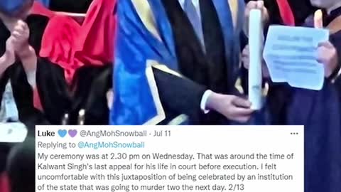 NUS student holds "abolish death penalty' sign during gradceremony