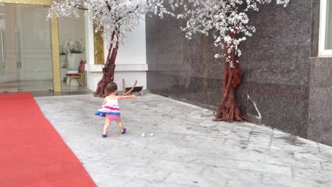 Little girl adorably chases paper in high wind gusts