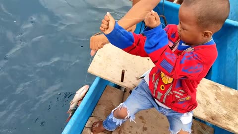 This little boy cried and pulled a big fish