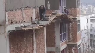 builders risking their lives working on unsecured tall building