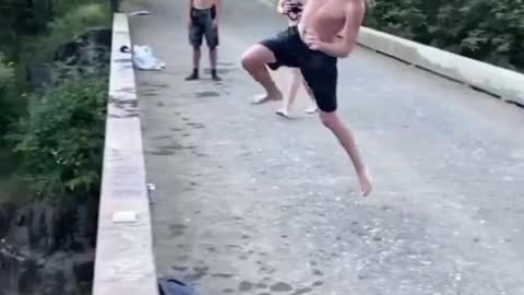 Man doing best parkour skills while jumping from bridge