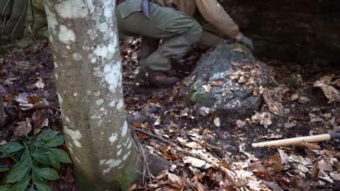 Four excavated shelter.Building underground bunker.Earth hut. primitive technology.Clay stone oven