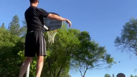 Guy Throws Rugby Ball in Basket From Distance While Balancing Over Fitness Ball