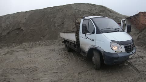 front loader loading 5 tons of sand into a Russian truck