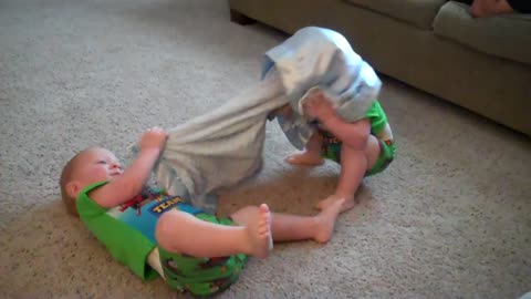Twin boys playing with their Boston Terrier dog