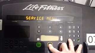 How to access the system menu on a LifeFitness treadmill