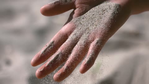 Sand on hand slow-motion video