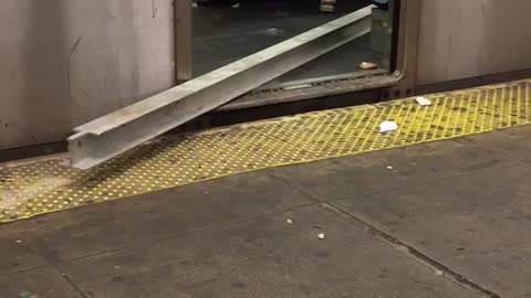 Man carries a metal beam on subway train