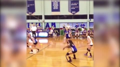 Two Girls Collide Playing Volleyball