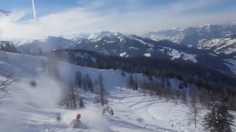 Orange helmet backflip loses skis