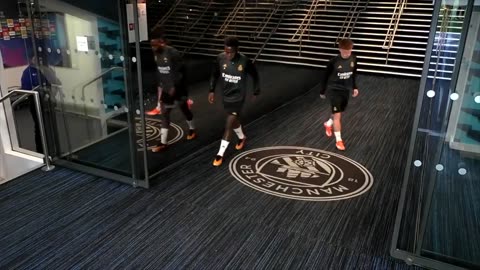 Real Madrid players show respect to Manchester City's logo.