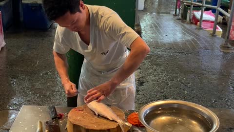 Man Prepares Milkfish in Philippine Market