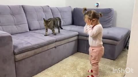 Cat enjoying playing with baby girl!