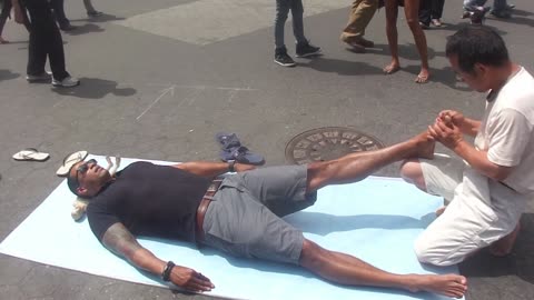 Luodong Massages Dark Skinned Tattooed Man On Sidewalk