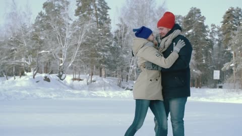 A Man And A Woman In An Outdoor Skating Rink