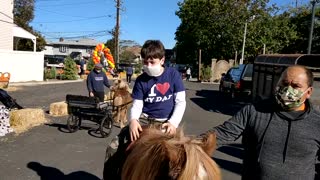 Spencer riding a Pony at Halloween festival