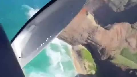 A helicopter's engine fails along Kauai's Nāpali Coast, crashing onto a beach