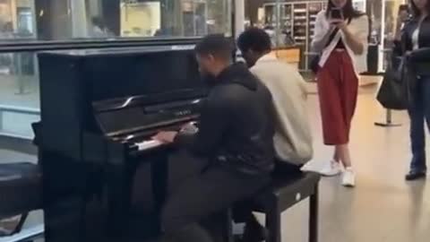 Two guys play interstellar theme at the mall